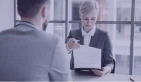 A consultant presenting a document across a desk